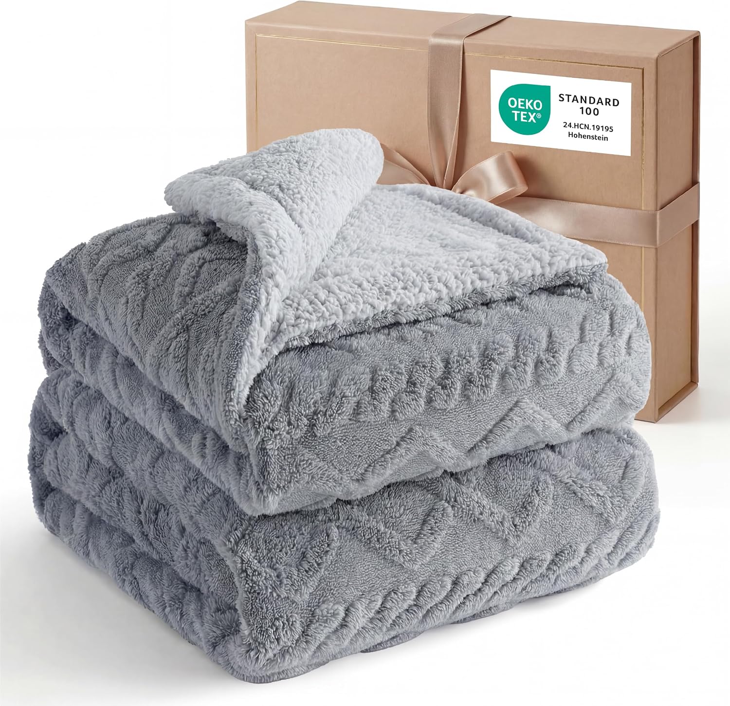שמיכת פליז שרפה Bedsure אפורה עם דוגמת כבל, מקופלת ליד קופסת מתנה